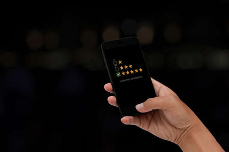 Young man using smartphone with virtual screen on the smiley face icon on the digital touch screen....