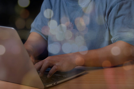 Close up man hands typing on laptop keyboard and surfing the internet on office table, online,...