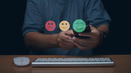 Businessman using laptop choosing screen on the happy Smiley face icon to give satisfaction in...