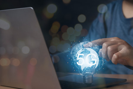 Businessman using a laptop and touching light bulb with 5G network technology, Global network...