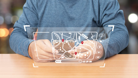 Man using smartphone with virtual model map with location point, icon maps and find places in the online system, Connection line over the map, Navigation concept.の写真素材