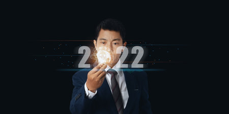 Businessman holding light bulb with virtual Global Internet connection 2022 and metaverse. internet...