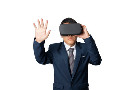 Studio portrait businessman wearing VR Headset touching something isolated on gray background. Glasses of virtual reality. Technology, gaming, entertainment and people concept. copy space.の写真素材