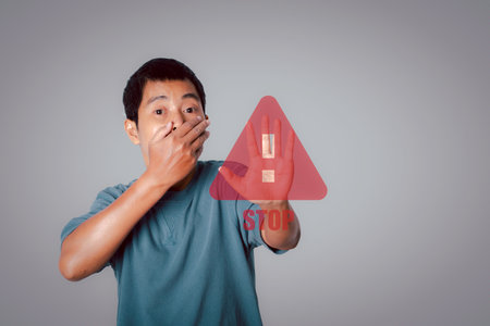 Young man showing stop gesture with stop sign virtual screen. Warning and alert attention signs....