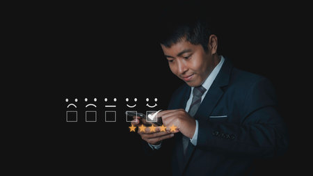 Customer satisfaction experience concept. Businessman choosing  happy smiley face icon to give satisfaction in service. rating very impressed. copy space.の写真素材