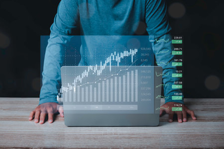 Stock Market Investments analysis and Digital Assets. Business finance technology and investment concept. Stock market graph with man working on laptop stock trading computer screen background.の写真素材