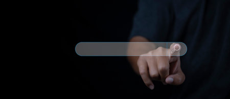 Searching browsing internet data information networking concept. Search Engine Optimization SEO Networking. Man hand presses the information search button on search bar virtual screen, copy space.の写真素材
