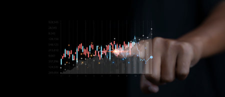 Stock Market Investments analysis and Digital Assets. Business finance technology and investment concept. Stock market graph with man touching stock trading screen background.の写真素材