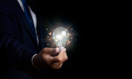 Creative idea and innovation. Businessman holding light bulbs the idea of...