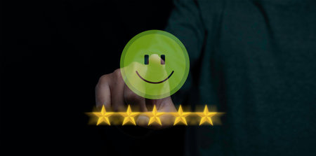 Customer satisfaction experience concept. Businessman choosing  happy smiley face icon to give satisfaction in service. rating very impressed. copy space.の写真素材