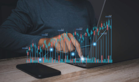 Stock Market Investments analysis and Digital Assets. Business finance technology and investment concept. Stock market graph with man working on laptop stock trading computer screen background.の写真素材