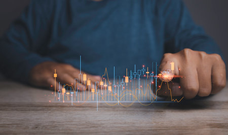 Stock Market Investments analysis and Digital Assets. Business finance technology and investment concept. Stock market graph with man working on laptop stock trading computer screen background.の写真素材