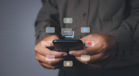 Social media and digital online on mobile phone. man using smartphone with social media to interactions icon on internet post. Data and marketing concept.の写真素材