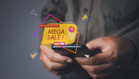 Shopping online by mobile smart phone. Young man using mobile phone shopping online with mega sale discount promotion, E-commerce business online. copy space.の写真素材
