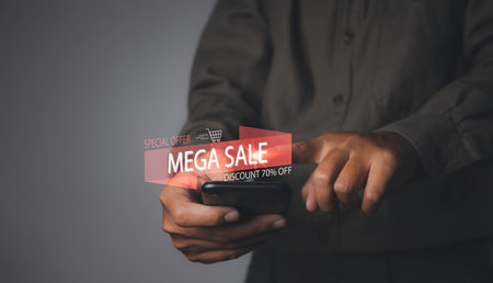 Shopping online by mobile smart phone. Young man using mobile phone shopping online with mega sale discount promotion, E-commerce business online. copy space.の写真素材
