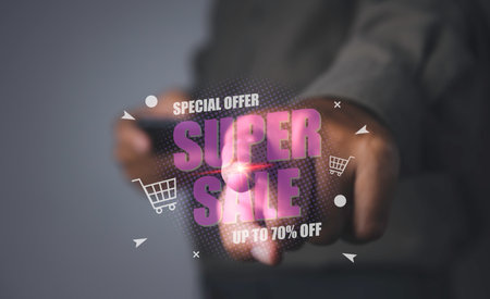 Shopping online by mobile smart phone. Young man using mobile phone shopping online with super sale discount promotion, E-commerce business online. copy space.の写真素材