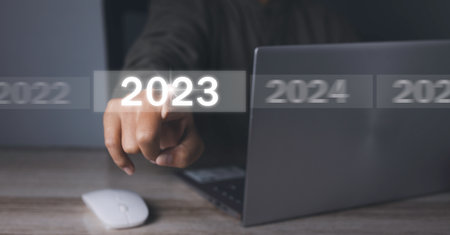 Welcome year 2023. Businessman hand pressing button New Year 2023 on virtual screen. New year 2022...