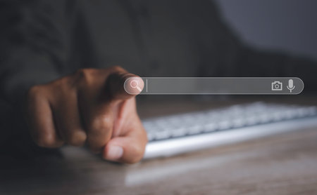 Searching browsing internet data information networking concept. Search Engine Optimization SEO Networking. Man hand presses the information search button on search bar virtual screen, copy space.の写真素材