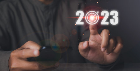 Business target and goal on new year 2023. Man pressing 2023 virtual screen with arrow up. Start up...