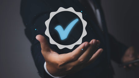 Man holding quality assurance icon or QA and Quality Control or QC. Quality management certification and standardization proces, ISO certified business, conformity to international standards.の写真素材