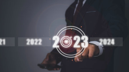 Business target and goal on new year 2023. Man pressing 2023 virtual screen with arrow up. Start up business in the future.の写真素材