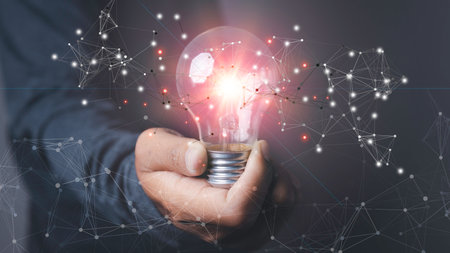New ideas and innovation technology and creative. Man holding light bulbs creative thinking new ideas. Business, Development, Concept creativity with digital network connection.の写真素材