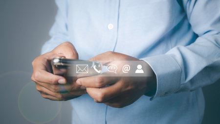 CONTACT US, Businessman using mobile smartphone support hotline people connect with contact icons ( email, address, live chat, internet wifi ). Customer service call center concept. copy space.の写真素材