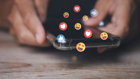 Social media and digital online on mobile phone. man using smartphone with social media to click like and love icon on internet post. Concept of living on vacation and playing social media.の写真素材