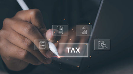 Businessman using computer to complete Individual income tax return form online for tax payment. Government, state taxes. Data analysis, paperwork, financial research, report.の写真素材