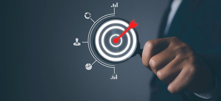 Businessman using magnifying glass with arrow dart icon and management target, success and planning....