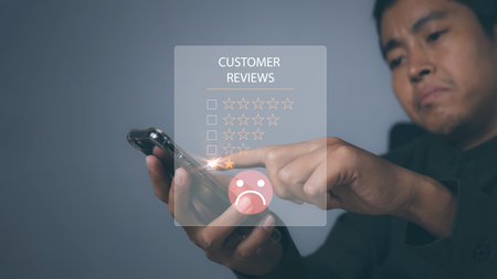 Bad review, bad service dislike quality, Customer satisfaction experience concept. Unhappy Businessman Client with Sadness Emotion Face on digital screen.の写真素材