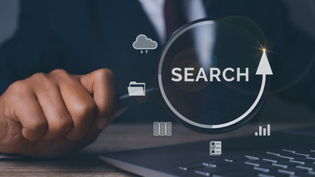 Businessman using magnifying glass search information networking with tablet. Job search, find a job, job interview. Data Search Technology Search Engine Optimization.の写真素材