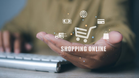 Man hand holding shopping cart and icons E-commerce marketing business online. Internet Technology, online shopping, business delivery e-commerce, service on the online web.の写真素材
