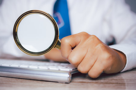 Businessman using magnifying glass searching data. Information in the internet world search technology Search Engine Optimization(SEO).の写真素材