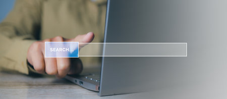 Searching browsing internet data information networking concept. Search Engine Optimization SEO Networking. Man hand presses the information search button on search bar virtual screen, copy space.の写真素材