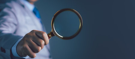 Businessman using magnifying glass searching data. Information in the internet world search technology Search Engine Optimization(SEO).の写真素材