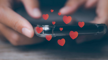 Young man using smartphone with social media to heart icon on internet post. Data and marketing concept. Social media and digital online on mobile phone.の写真素材