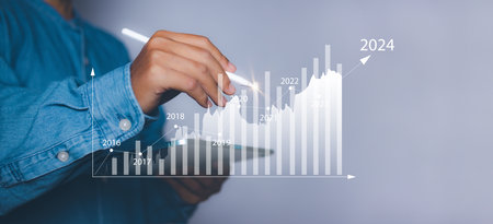 New years 2024 start up investment new business and finance. Businessman hand pointing graph on target 2024. Stock market, Business growth, progress or success.の写真素材