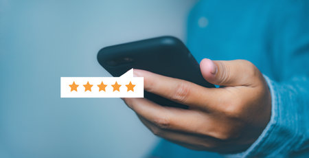 Businessman touching giving high score for feedback review satisfaction service. Customer satisfaction experience with five star icon and excellent for feedback review satisfaction service.の写真素材