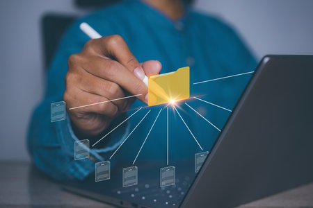 Document Management System (DMS), Businessman access folder and document icon software, searching and managing files online document database, for efficient archiving and company data.の写真素材