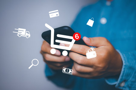 Man using mobile phone shopping online with icons E-commerce marketing business online. Internet Technology, online shopping, business delivery e-commerce, service on the online web.の写真素材