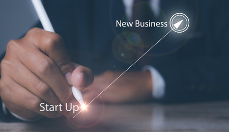 Businessman hand pointing startup in progress business growing potential with graph on target. Business growth, progress or success.の写真素材