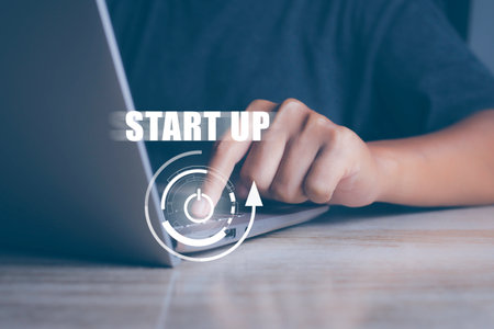 Businessman press button startup business on laptop. New business beginning.