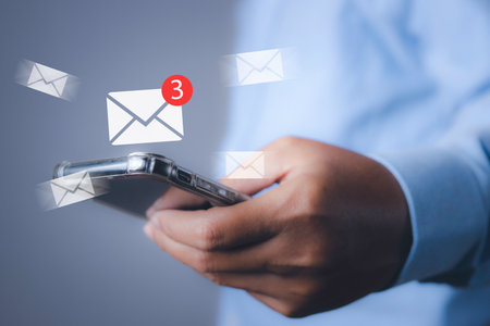 Businessman using smartphone with new email notification for business e-mail communication and digital marketing. Inbox receiving electronic message alert internet technology.の写真素材