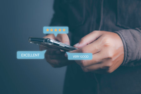 Customer satisfaction experience concept. Businessman giving high score with five golden stars rating satisfaction in service. rating very impressed. copy space.の写真素材