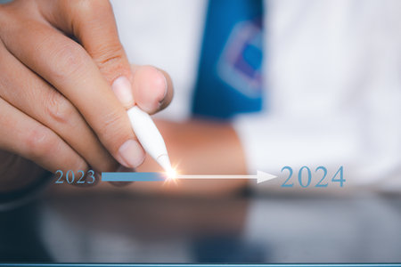 Businessman pointing target in 2024. Progress growing potential success new business.の写真素材