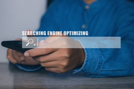 Businessman using smartphone to optimize online content with SEO tool with search bar.