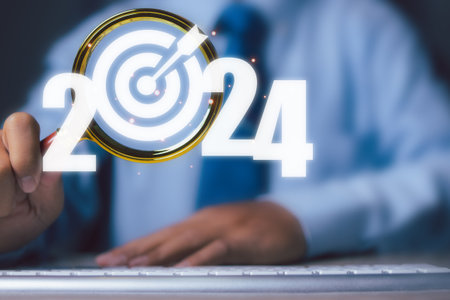 Businessman use magnifying glass with dartboard icon focus target business in 2024.