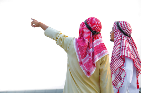 Two Arab businessmans point to target for investmentの写真素材