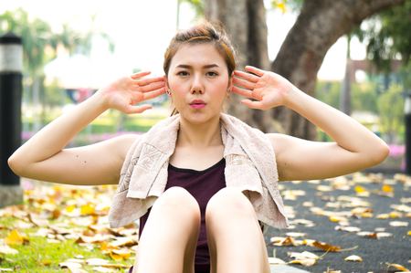 Asian sport woman exercise by sit up in parkの写真素材